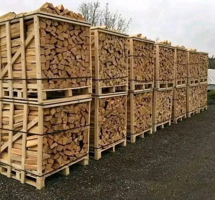 Split hardwood firewood logs stacked outdoors for seasoning
